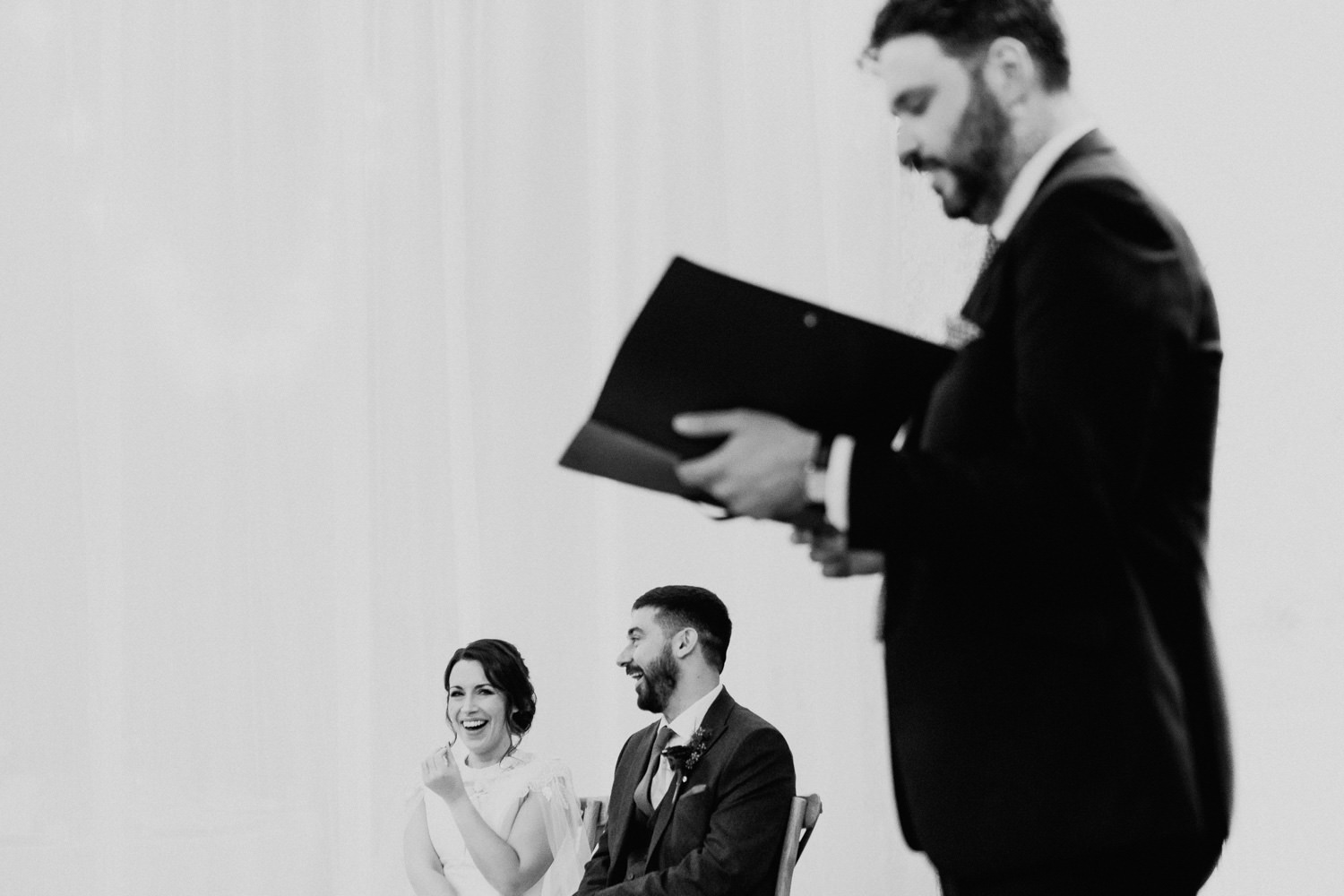 wedding couple laughing during ceremony 