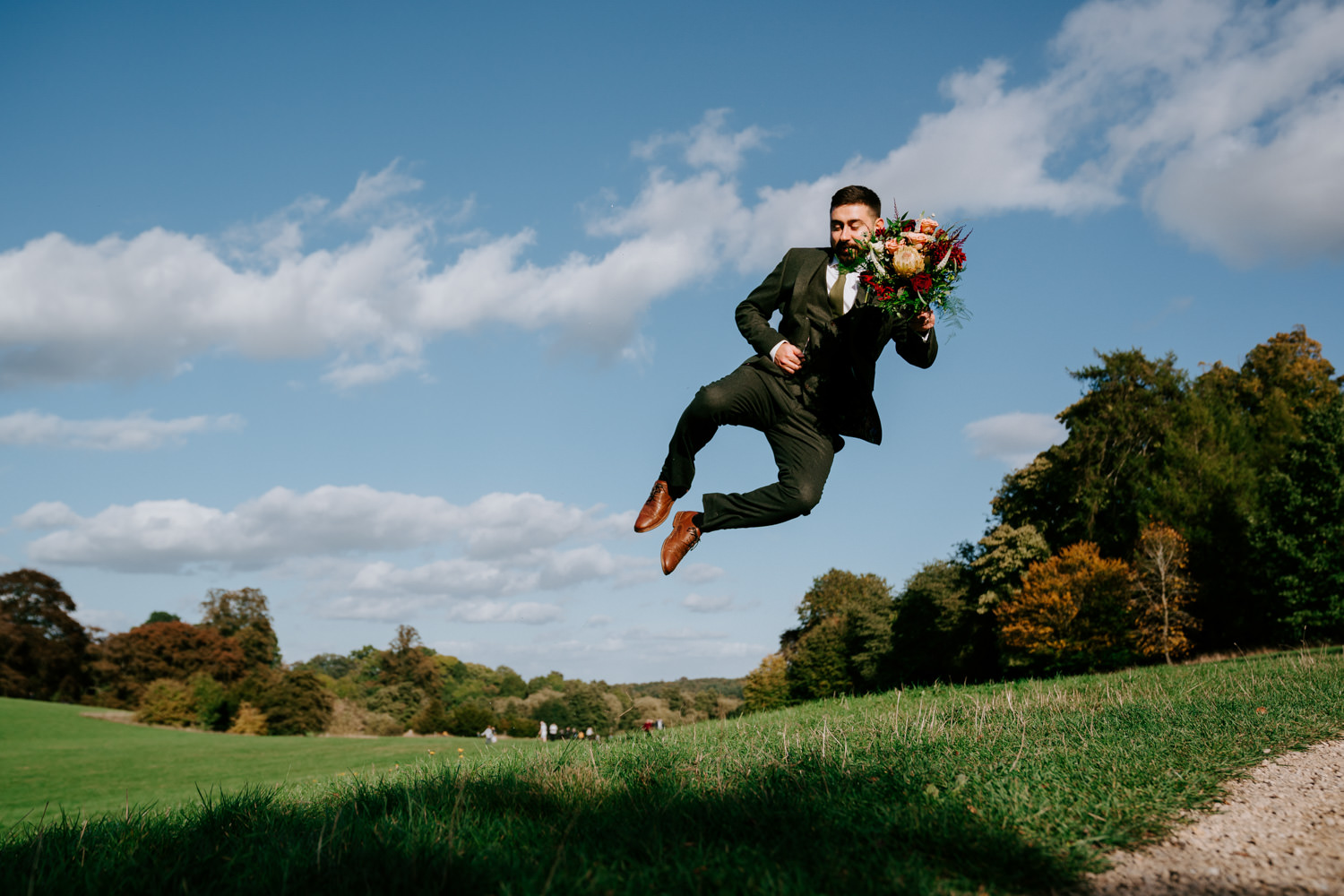 professional photograph of a groom jumping in the air 